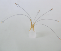 <em>Blue Topaz Flight - The Birds, pectoral piece on stand,</em> 18ct gold, blue topaz, steel cable on acrylic stand, 12 x 22 x 0.8cm, no 0752.