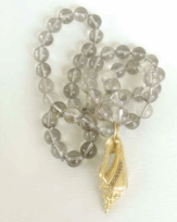 <em>Strombus III and Smokey quartz - Seashore Collection, </em>Pendant, 18ct gold, st. steel, orange A diamonds (.127 cts,) no 0719, on strand of smoky quartz beads, 15 x 18 x 1.0 cm, no 0738.